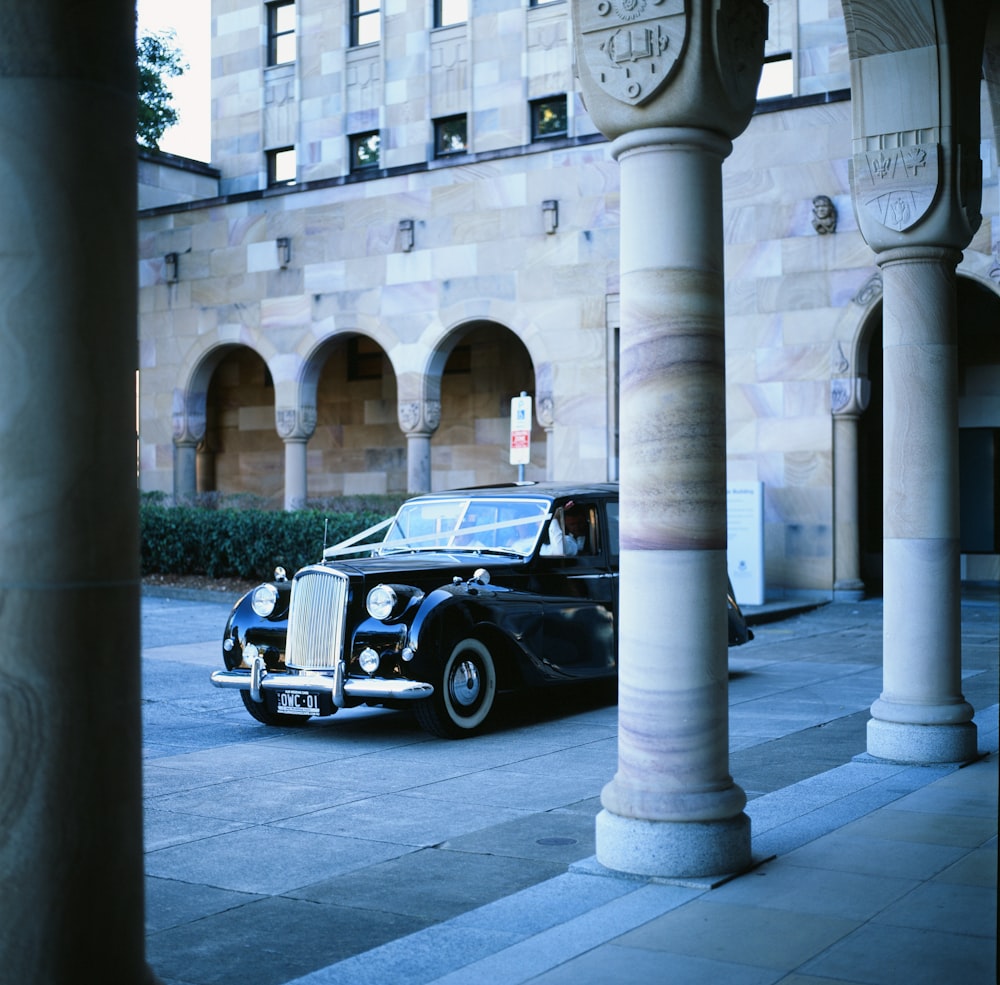 a black car parked in front of a building