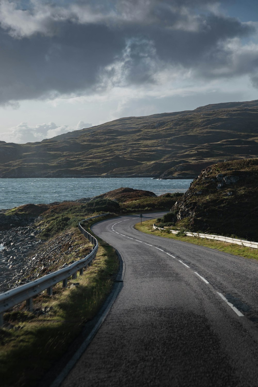 an empty road near a body of water