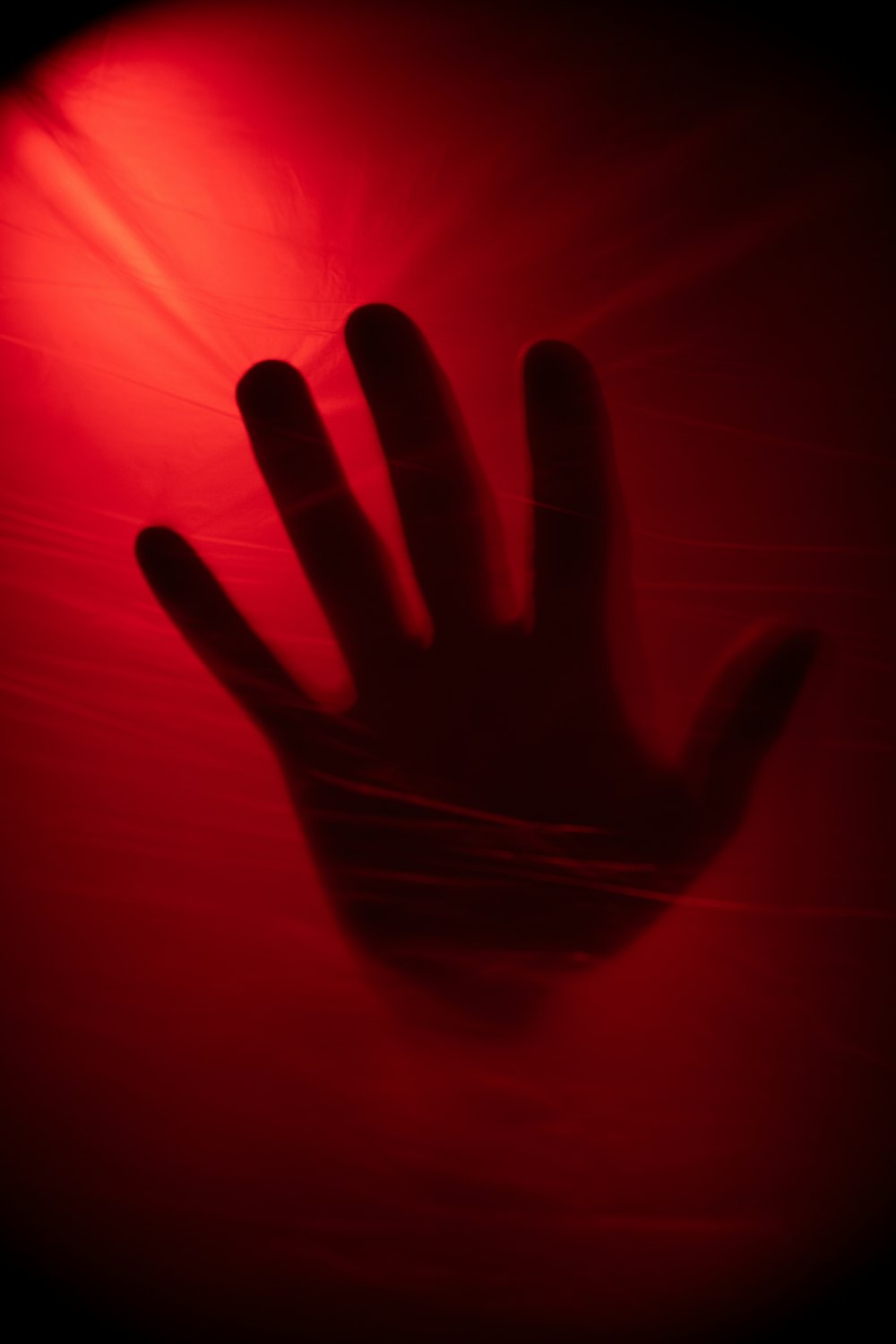 a person's hand on a red background