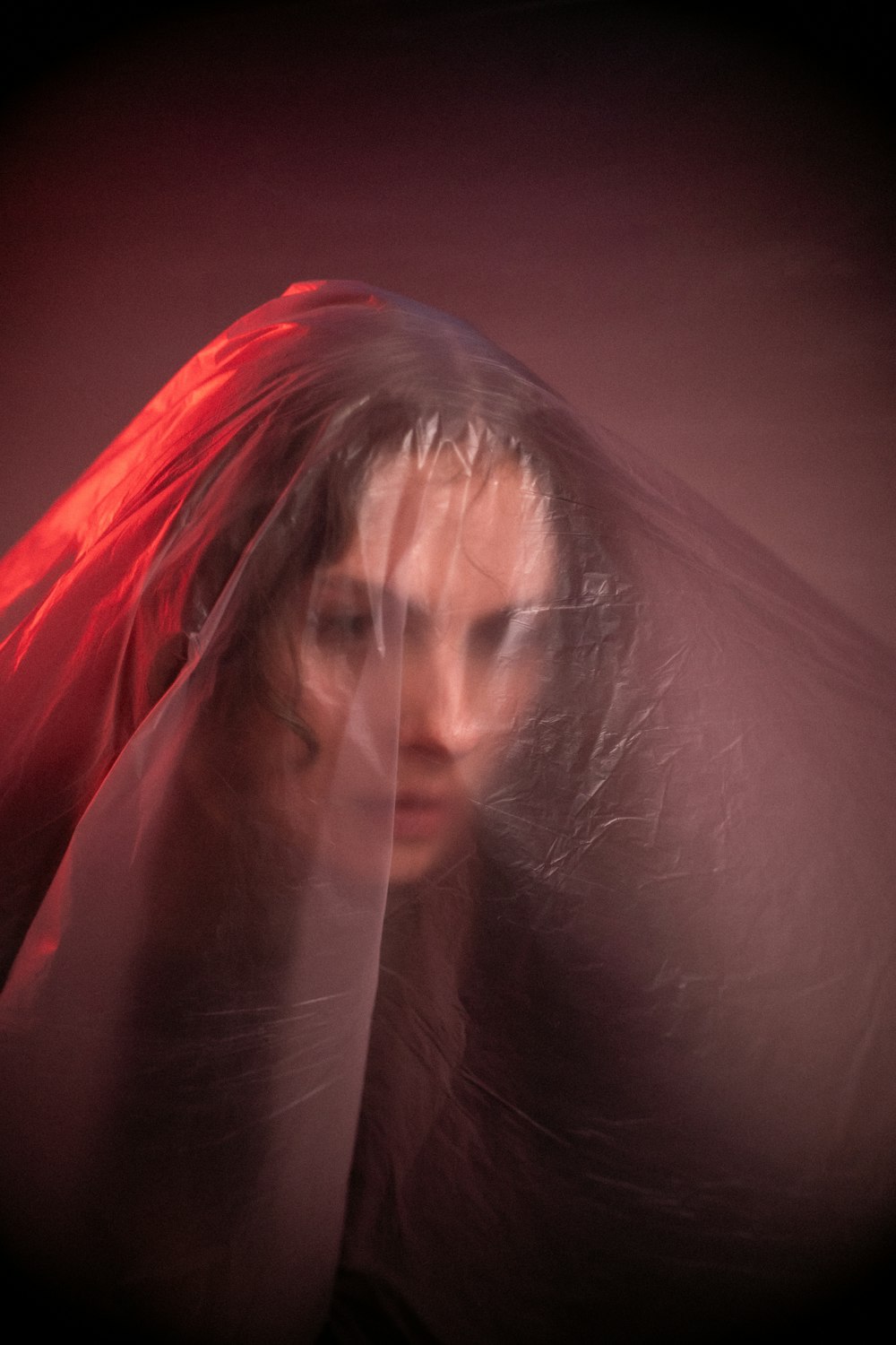 a woman with a red veil on her head