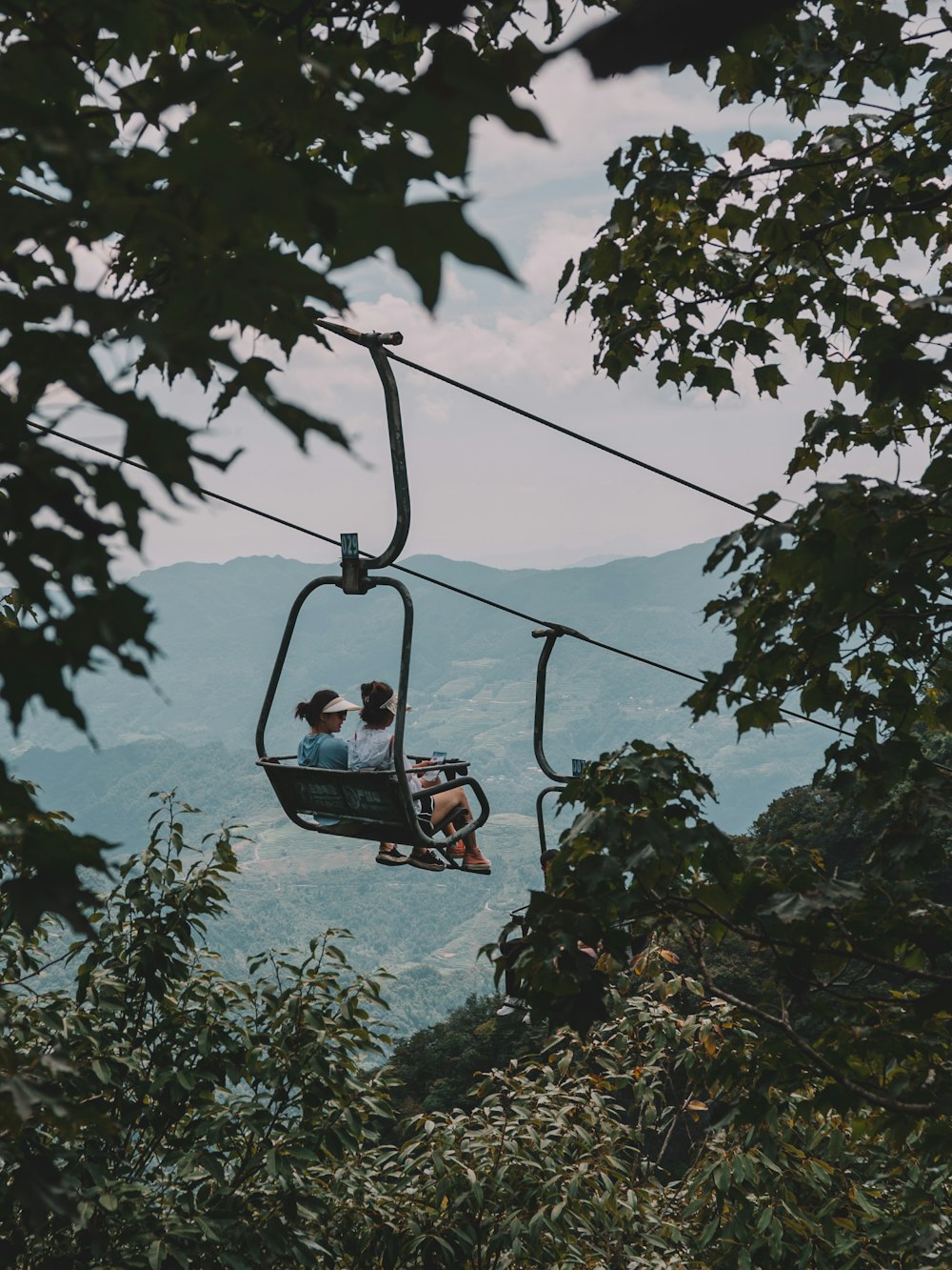 a couple of people riding a ski lift