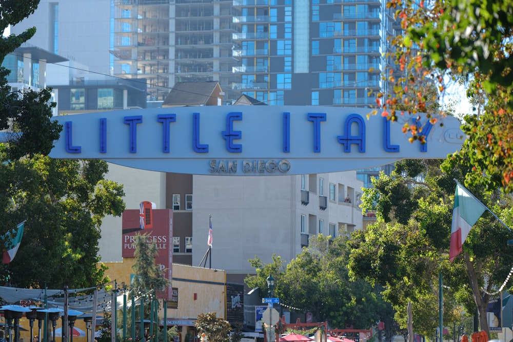 a sign that says little italy above a city street