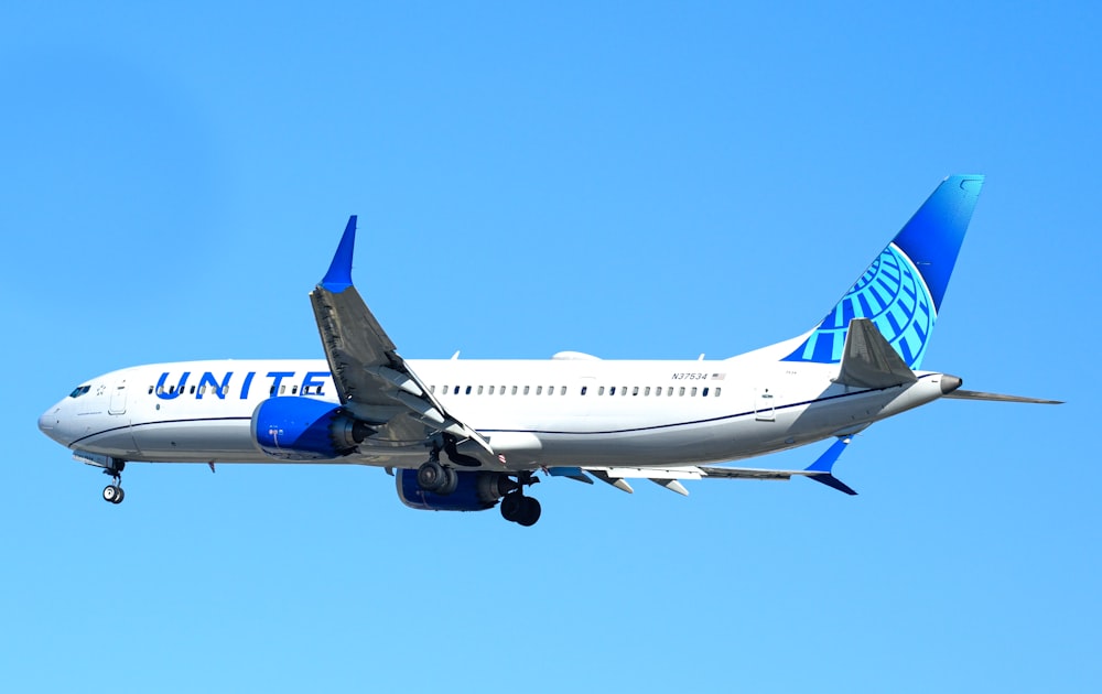 a large jetliner flying through a blue sky