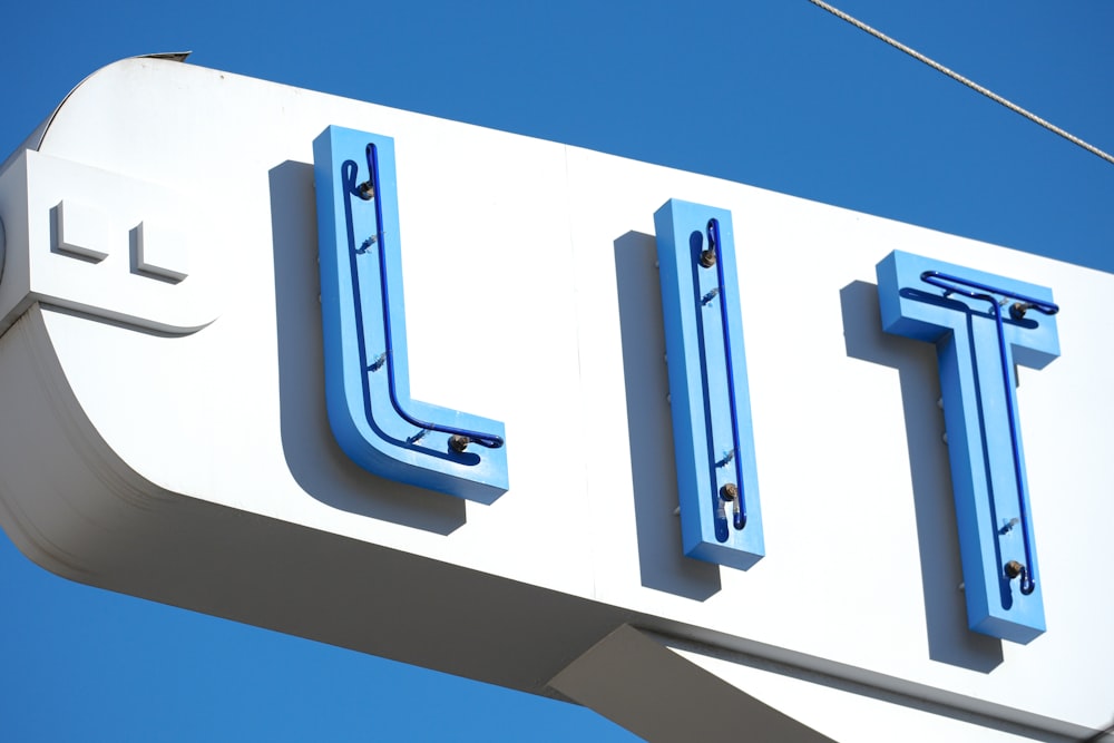 a close up of a sign with a sky background