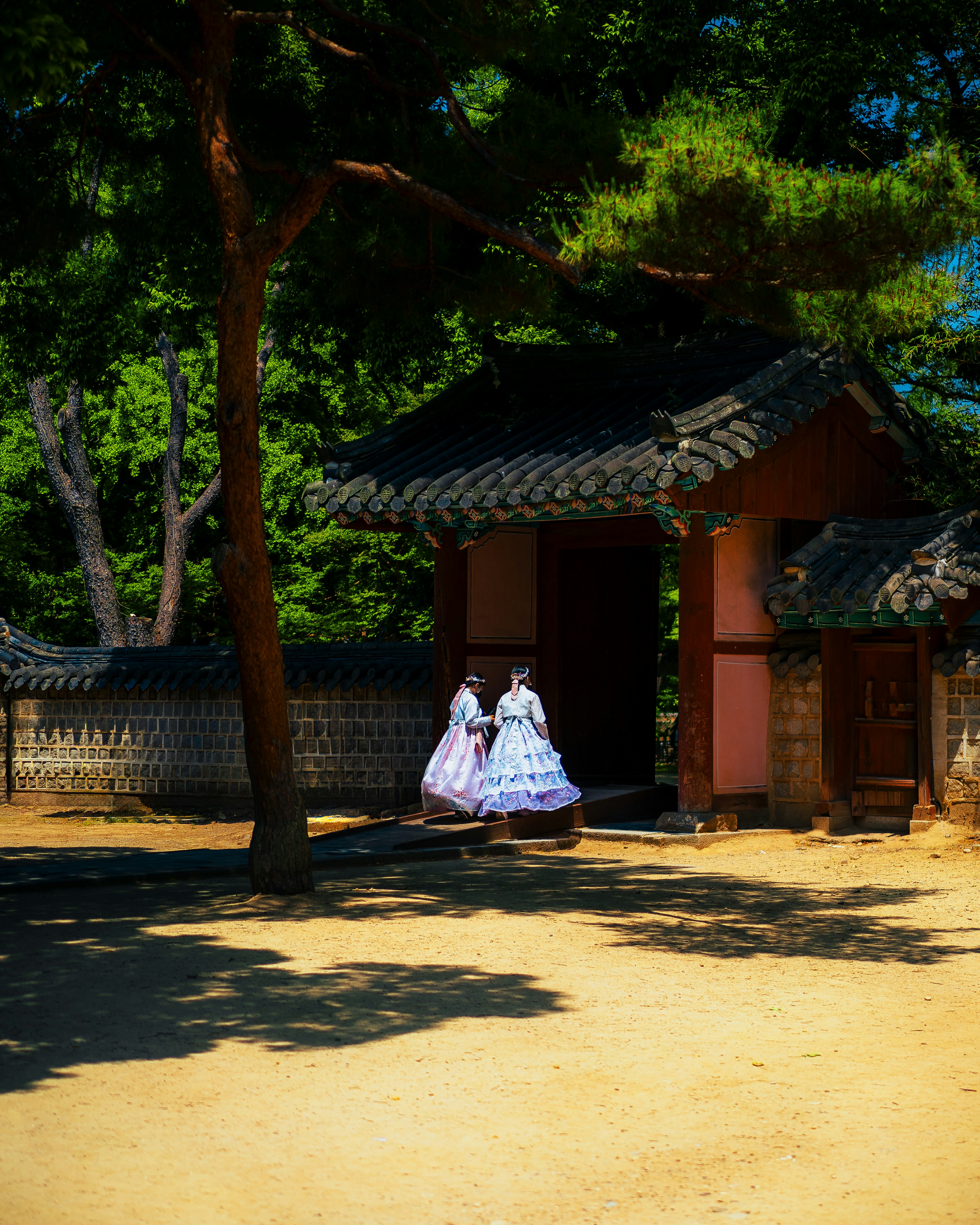 a woman in a white dress standing in front of a building