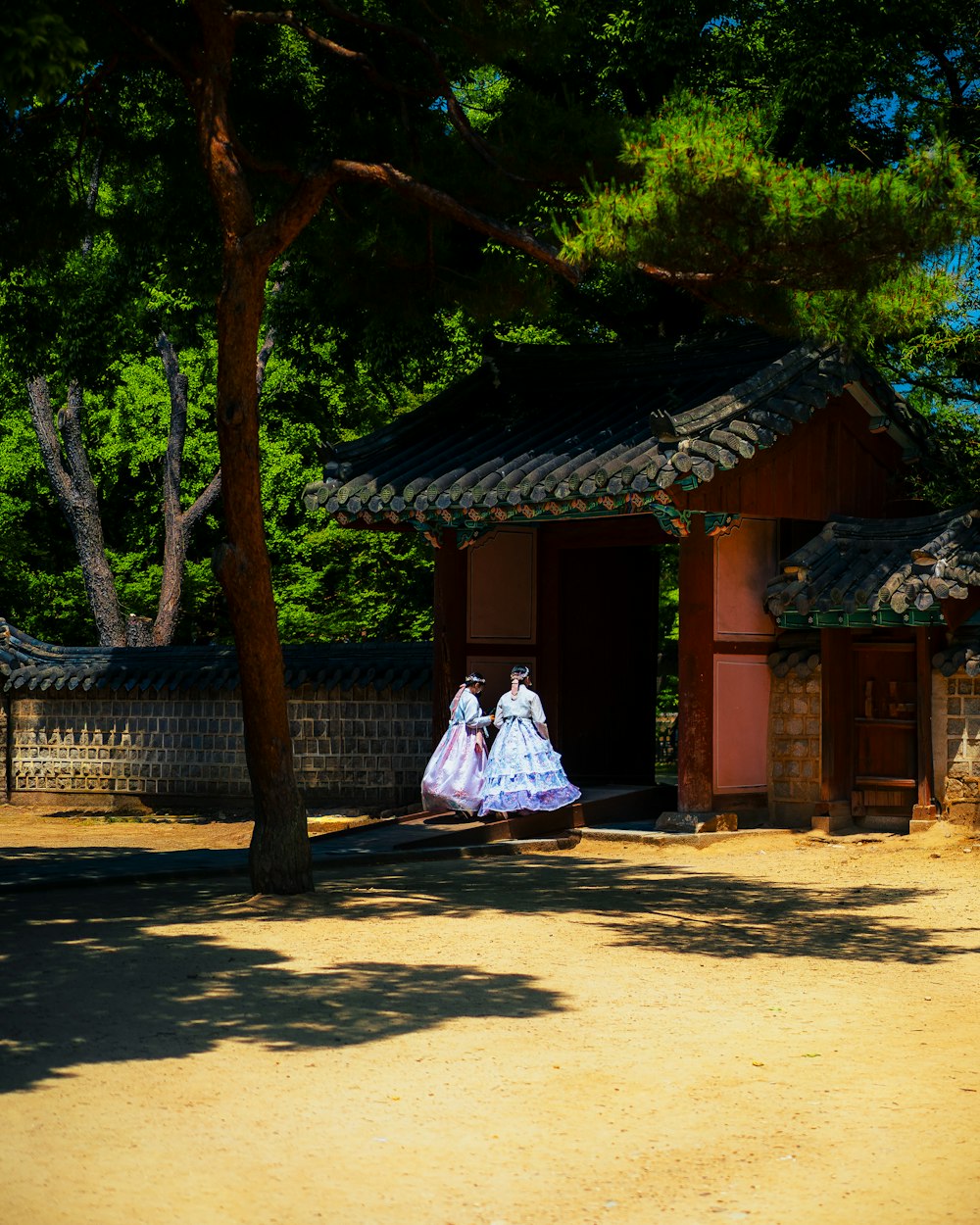 a woman in a white dress standing in front of a building