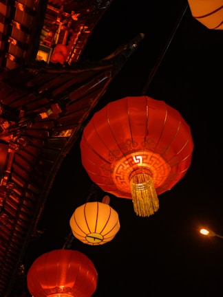 Colorful lanterns floating in the night sky at a Korean cultural celebration.