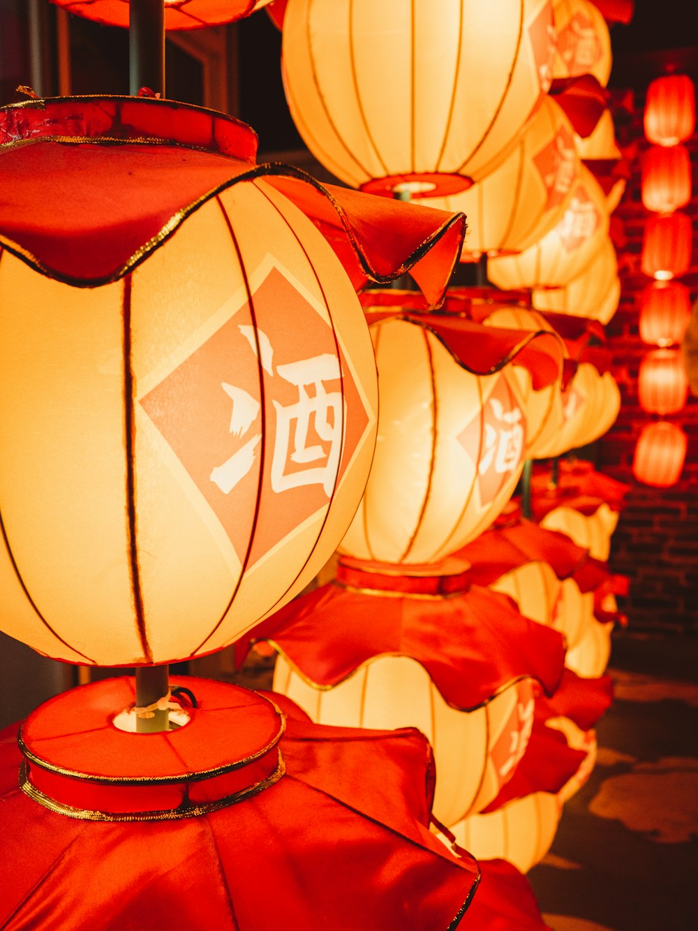 a row of lanterns with chinese writing on them