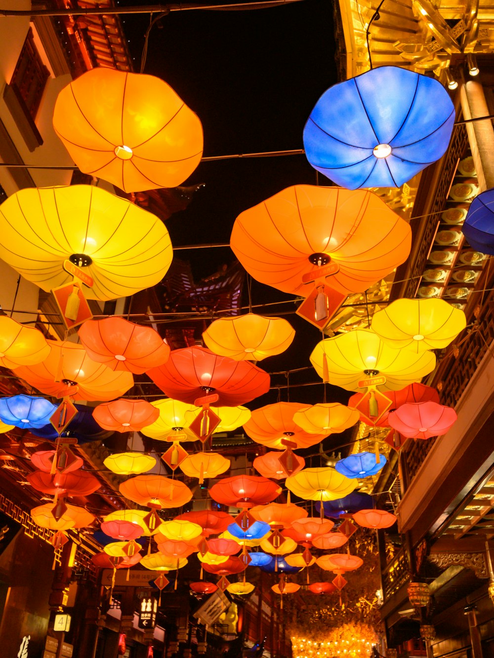 a bunch of colorful umbrellas hanging from the ceiling
