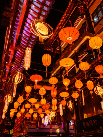 Vibrant street scene in Bali with colorful lanterns and lush tropical greenery.
