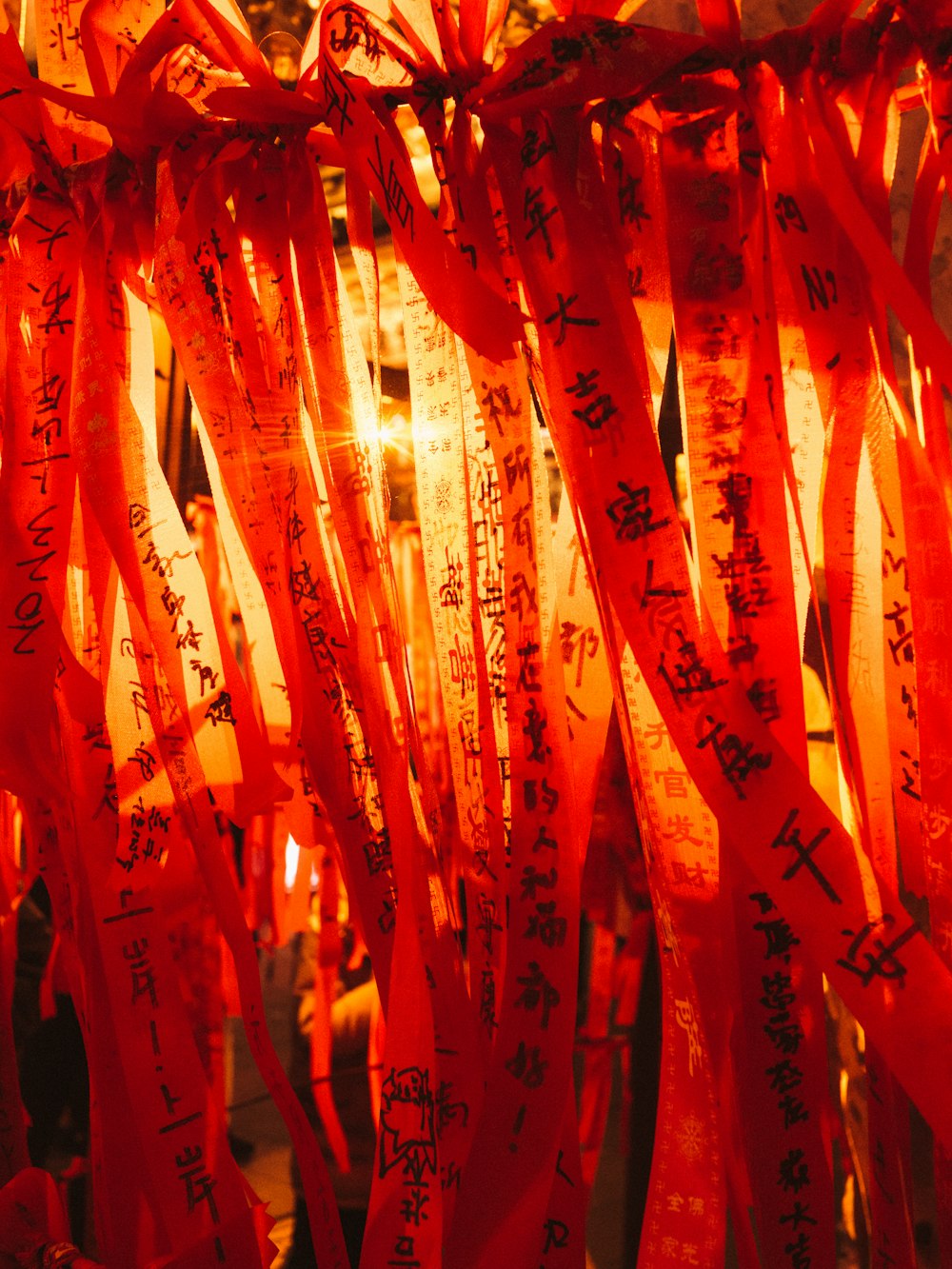 a bunch of red ribbons with writing on them