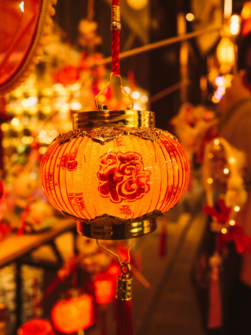 a red and white lantern hanging from a string