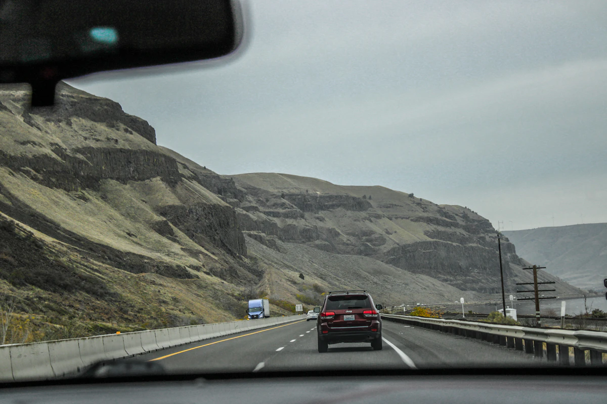 Vehicle on scenic highway with landscape views
