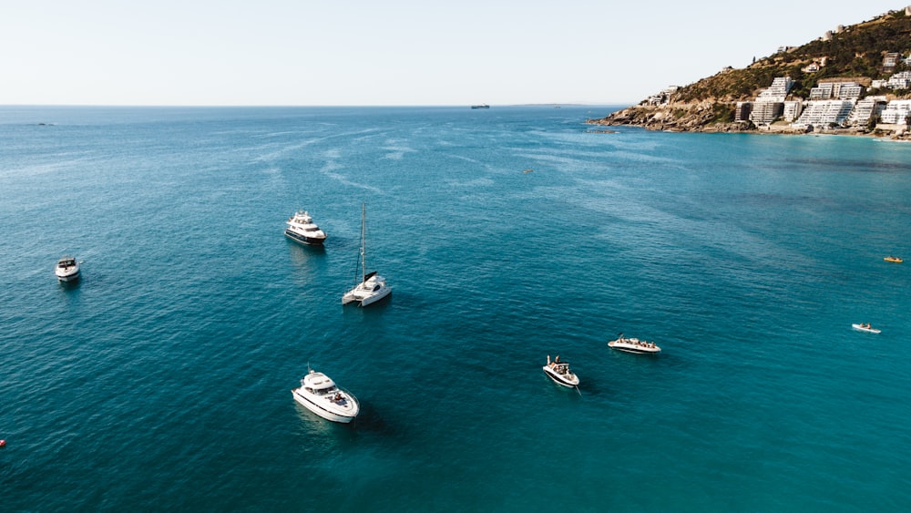 a group of boats floating on top of a body of water