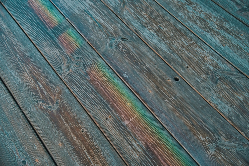a wooden floor with a rainbow painted on it