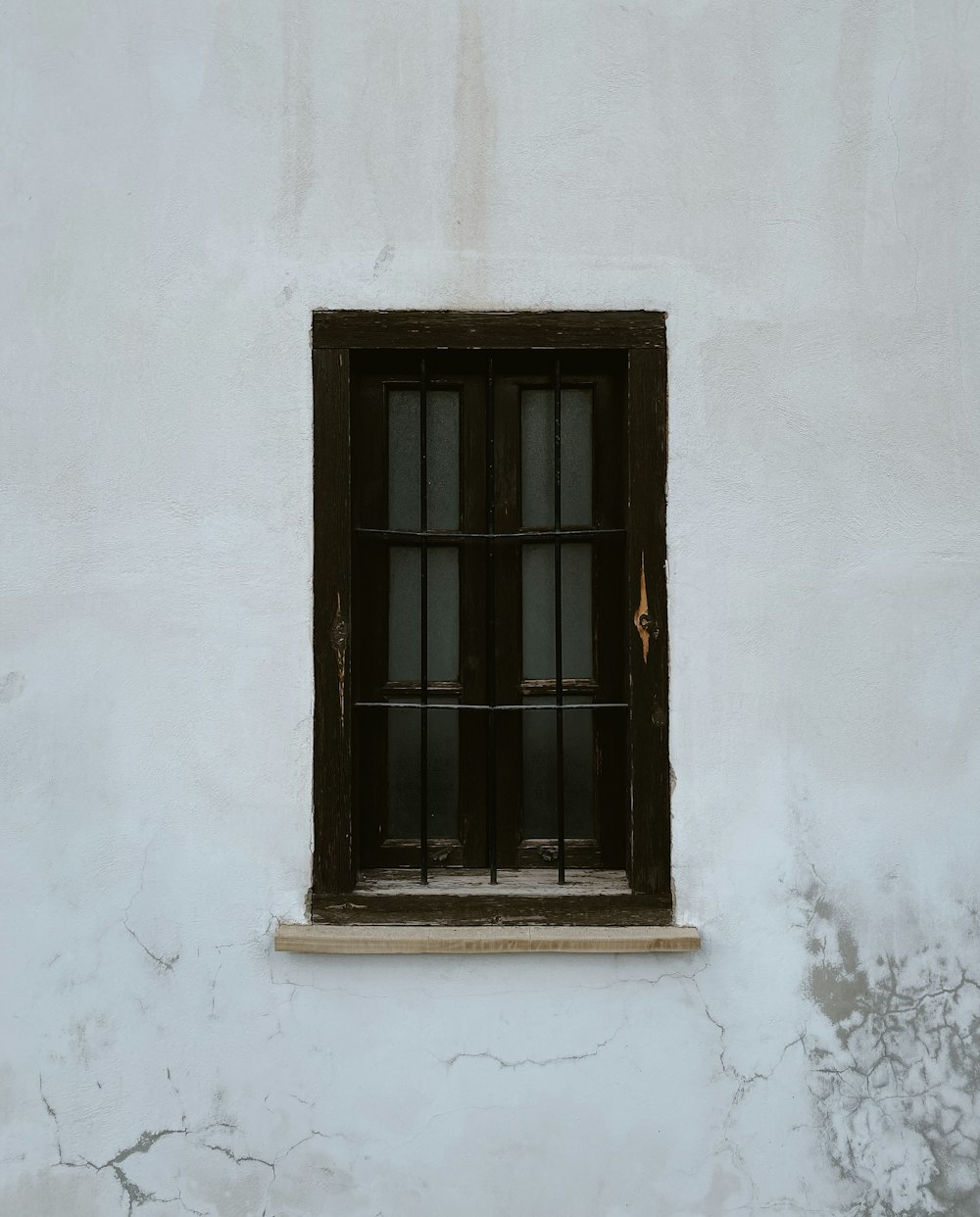 a window with bars on the side of a building