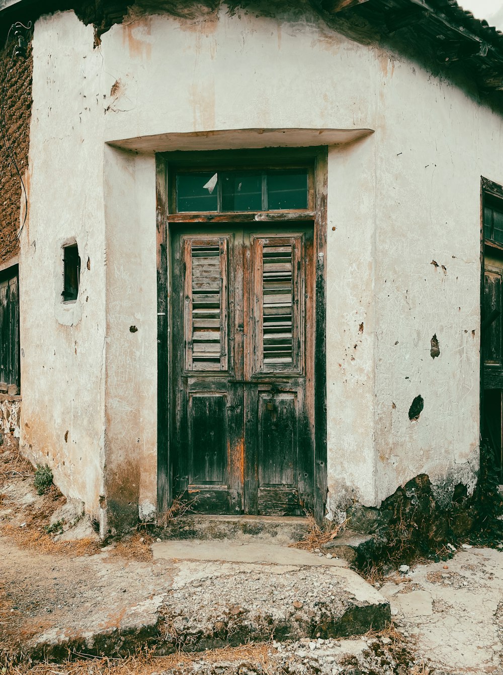 an old run down building with a wooden door