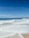 A tranquil beach scene with gentle waves and soft sand.