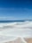 A tranquil beach scene with gentle waves and soft sand.