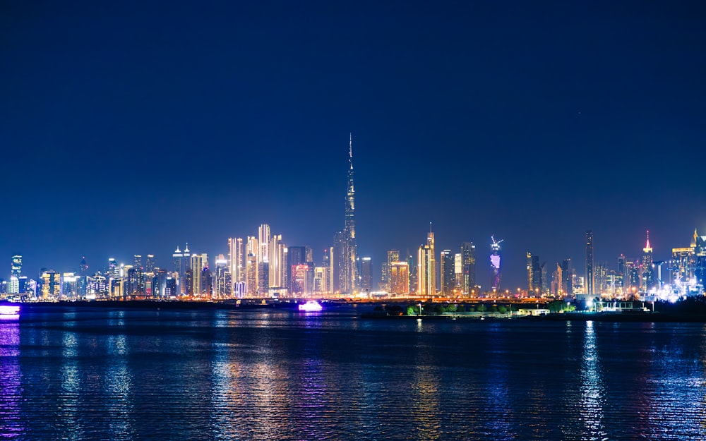 a city skyline is lit up at night