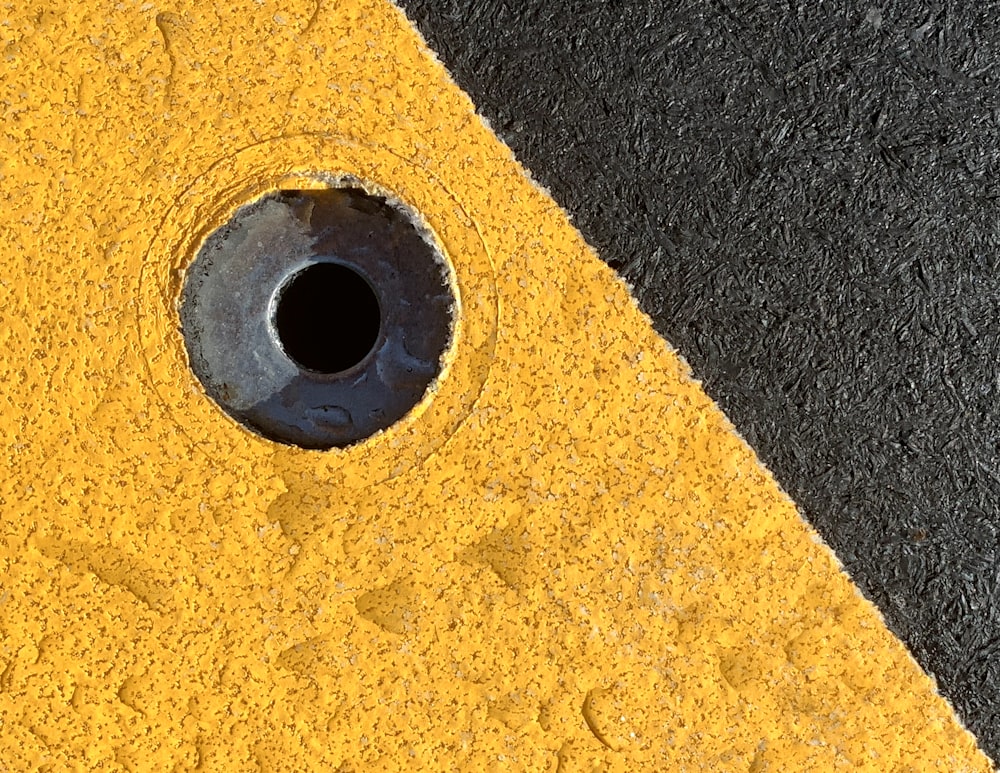 a close up of a yellow and black street curb