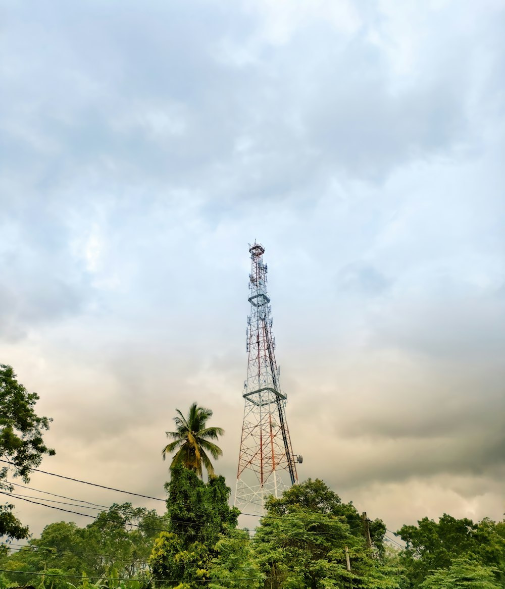 a tall tower sitting above a lush green forest