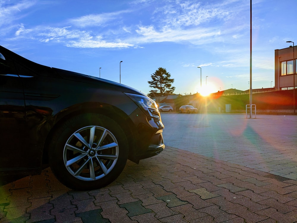 a car parked in a parking lot at sunset