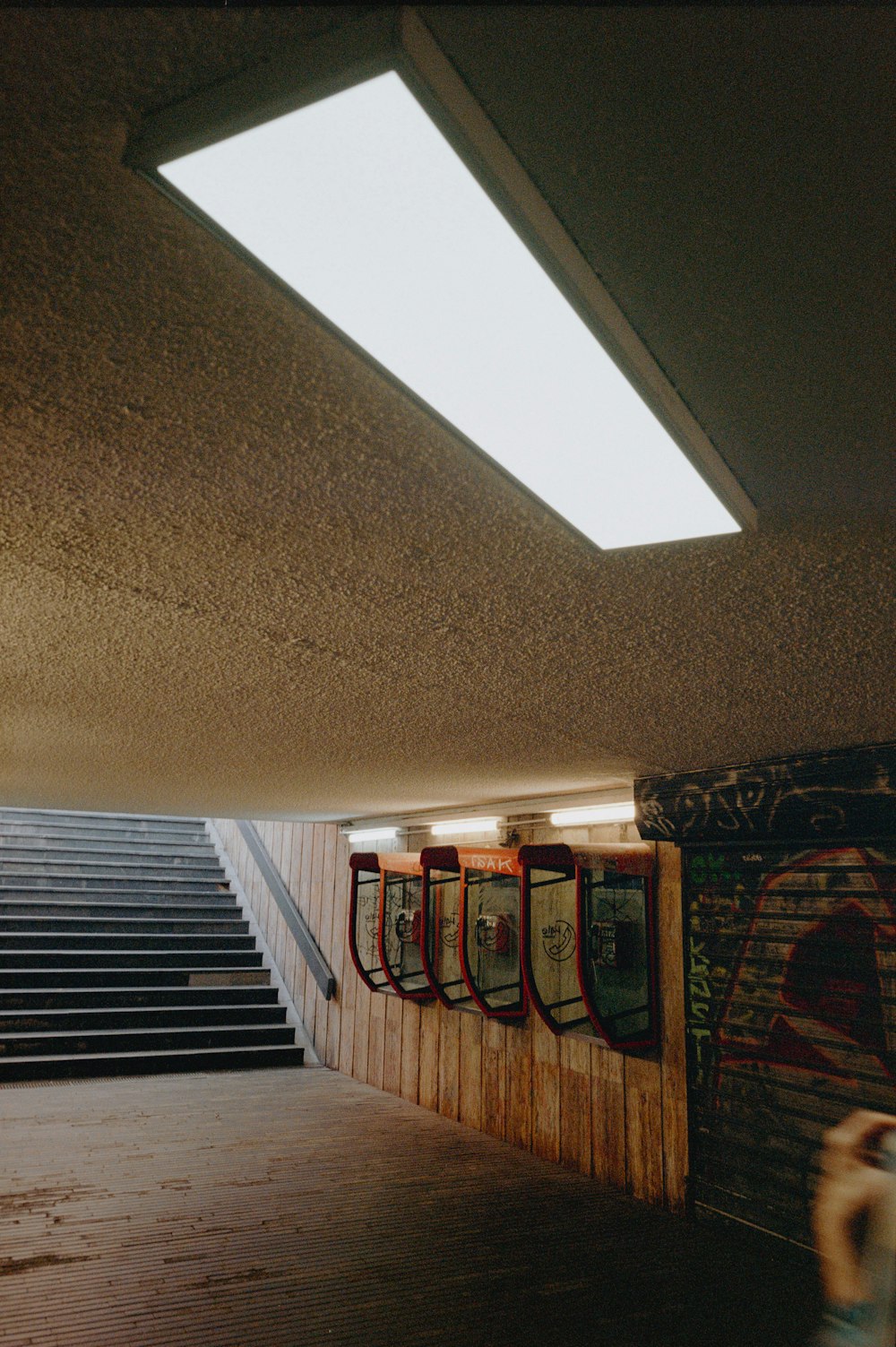 a row of urinals sitting next to a stairway