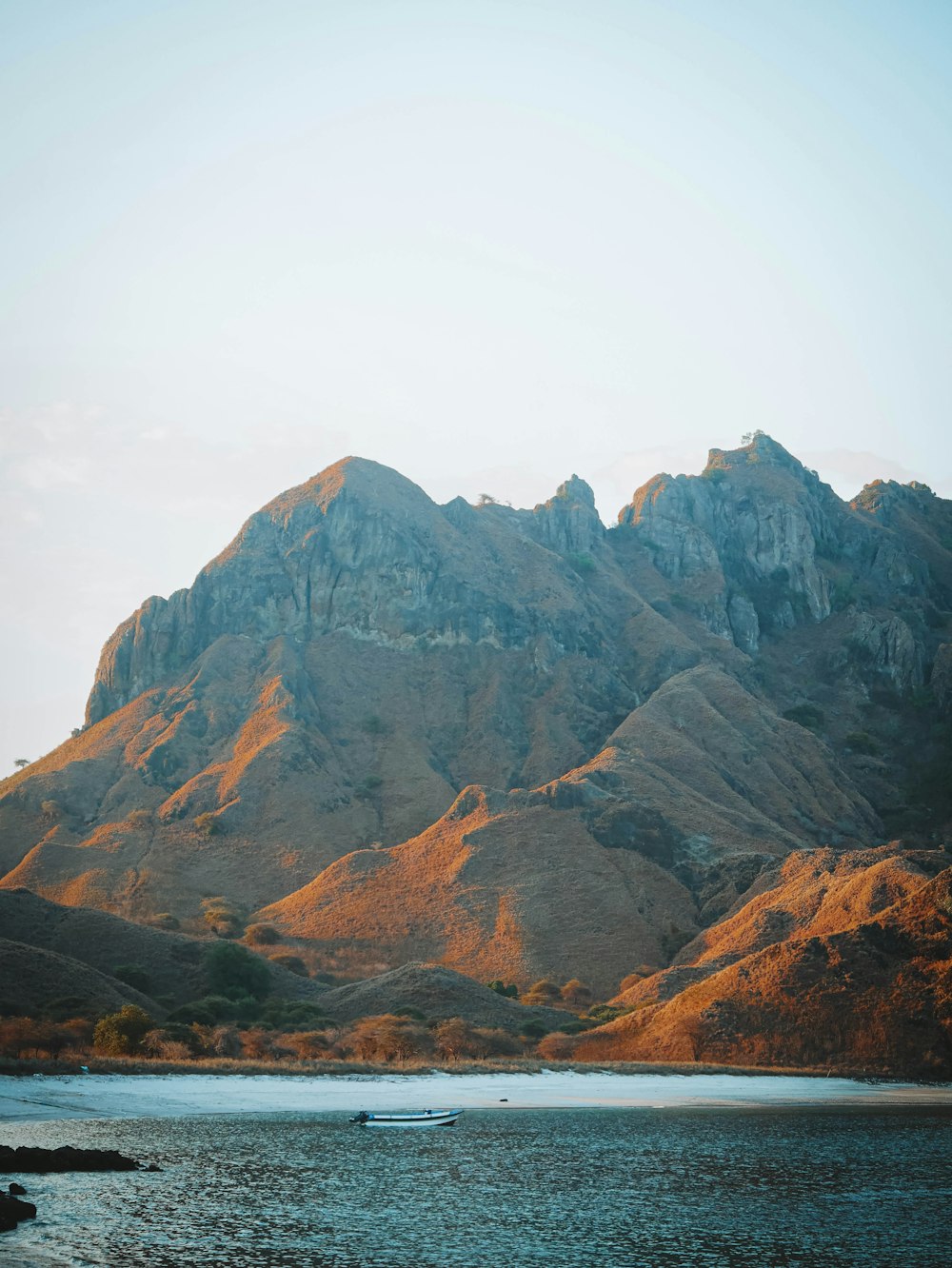 a mountain with a body of water in front of it