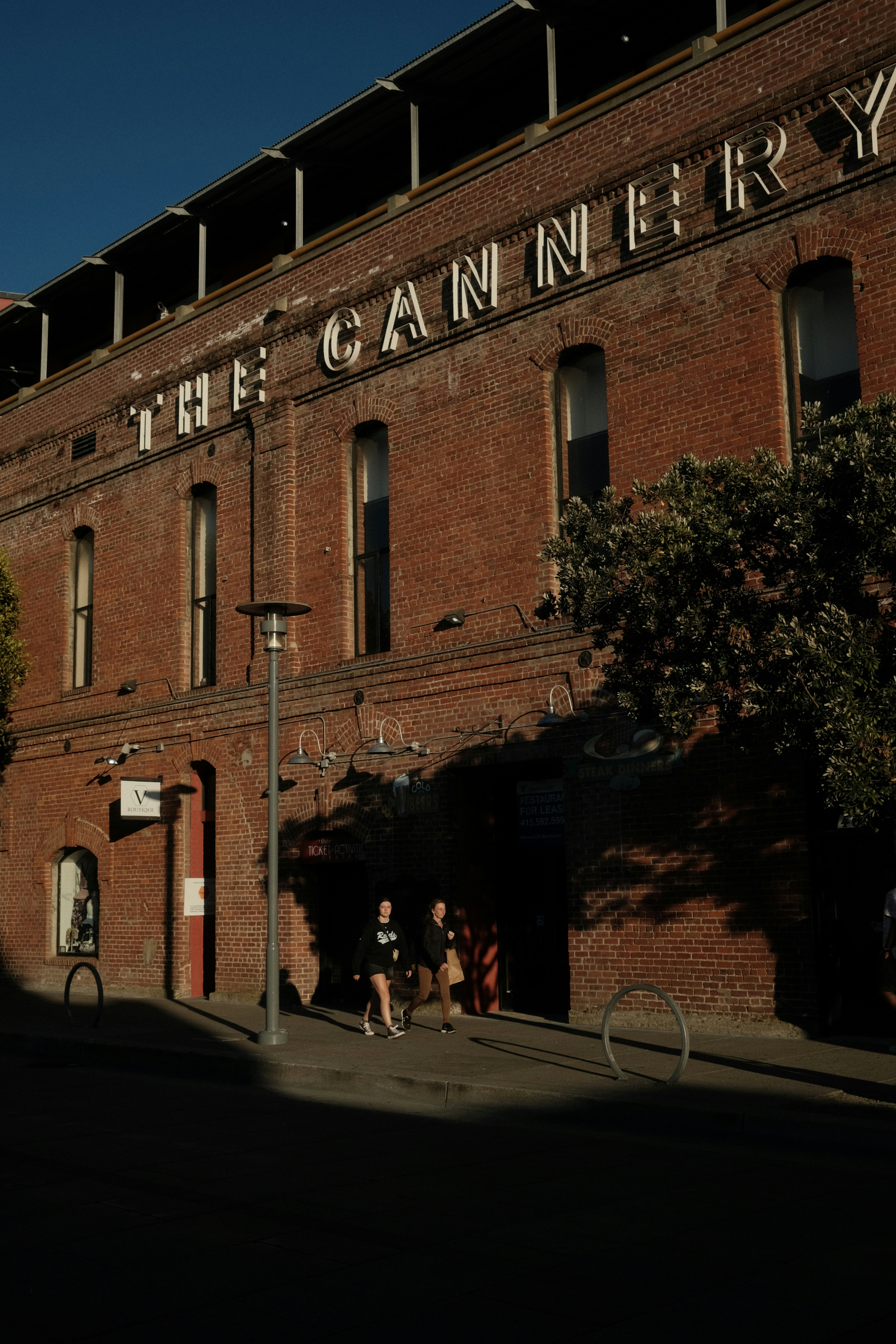 a tall brick building sitting next to a street