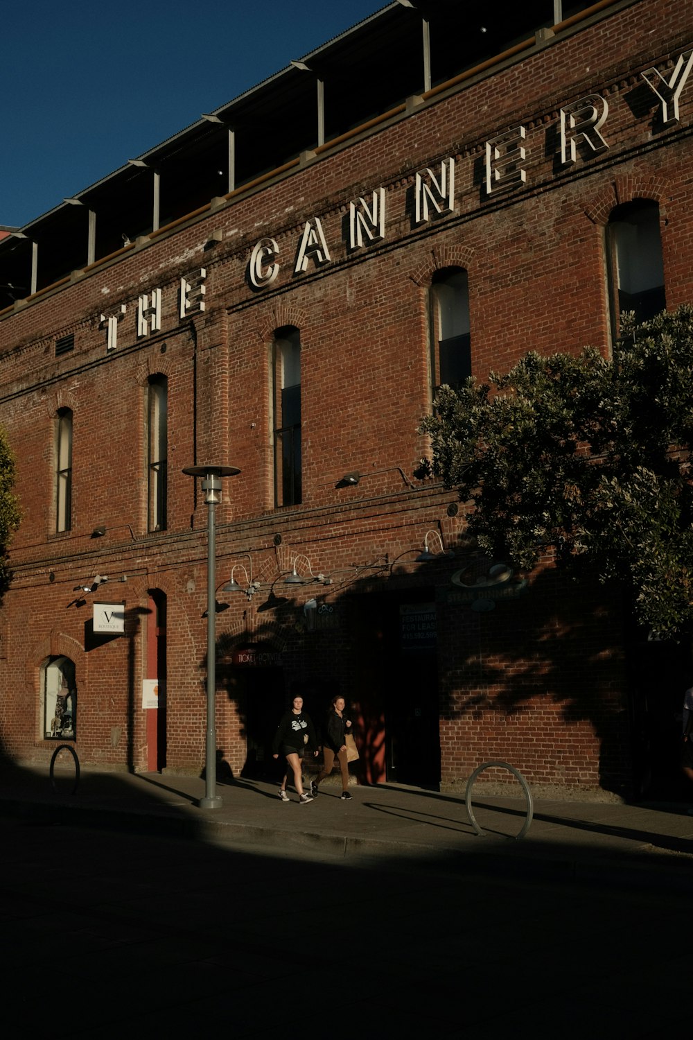 a tall brick building sitting next to a street