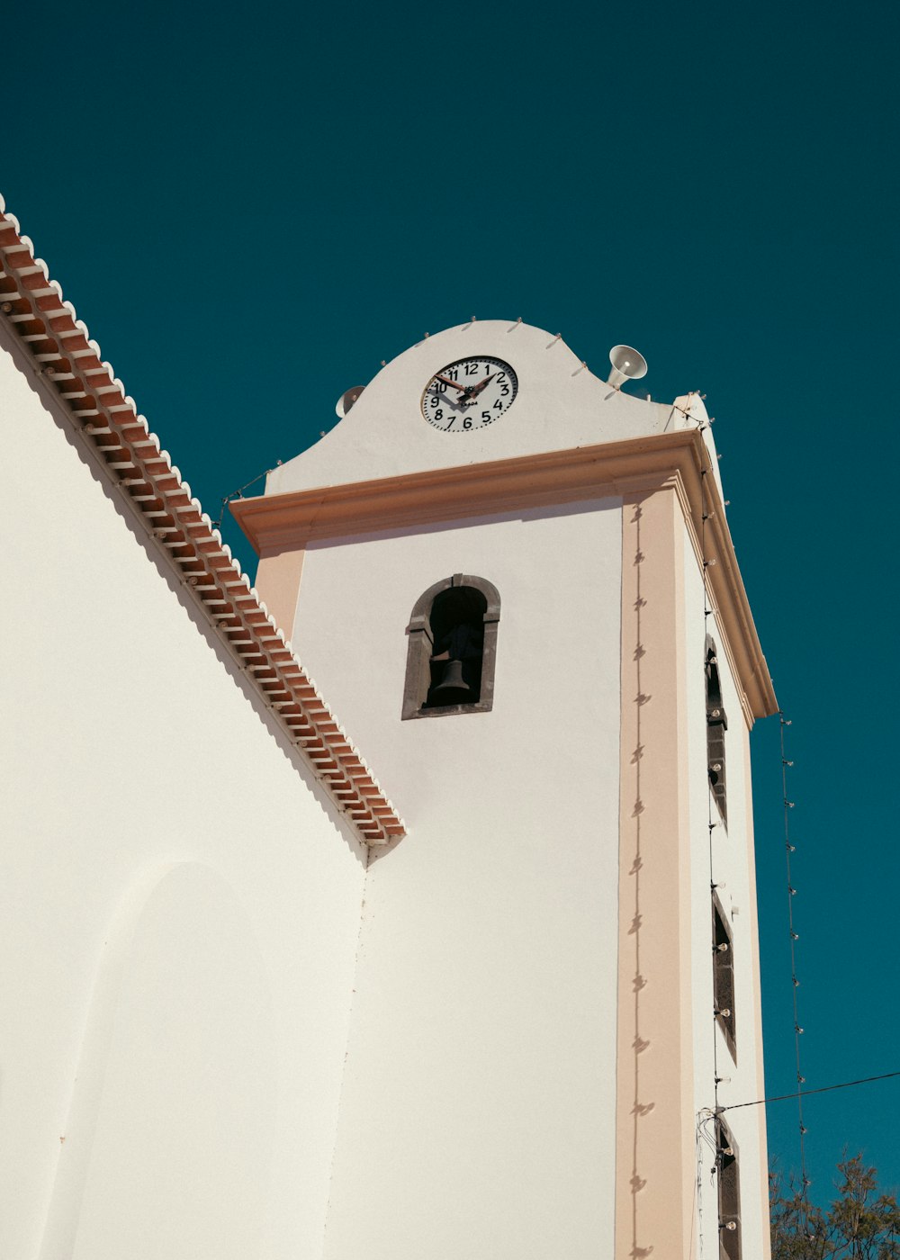 a clock on the side of a white building
