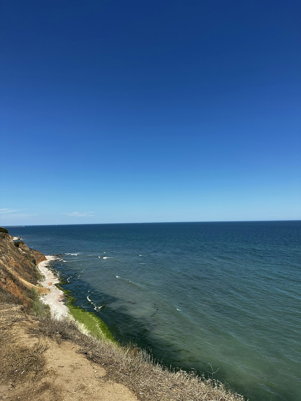 a large body of water sitting next to a cliff