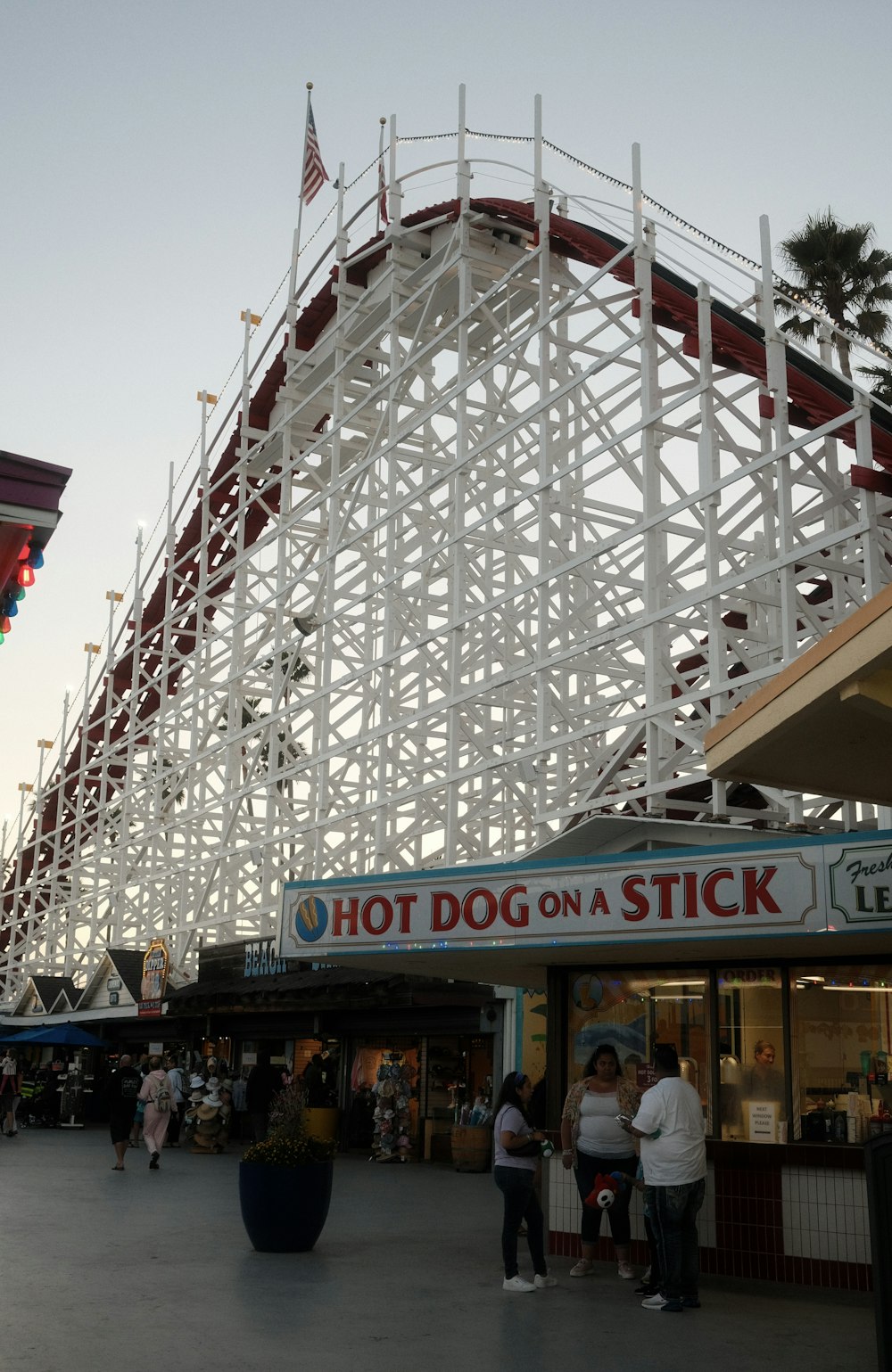 a roller coaster with people standing around it