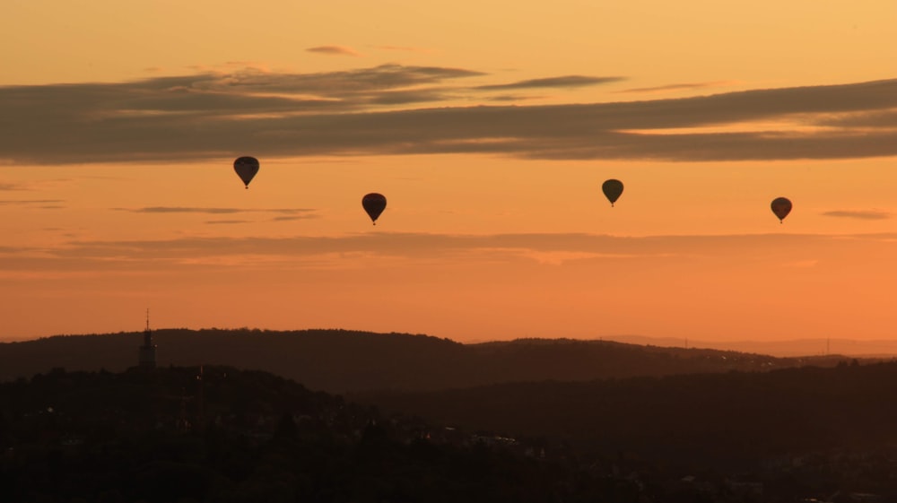 a group of hot air balloons flying in the sky