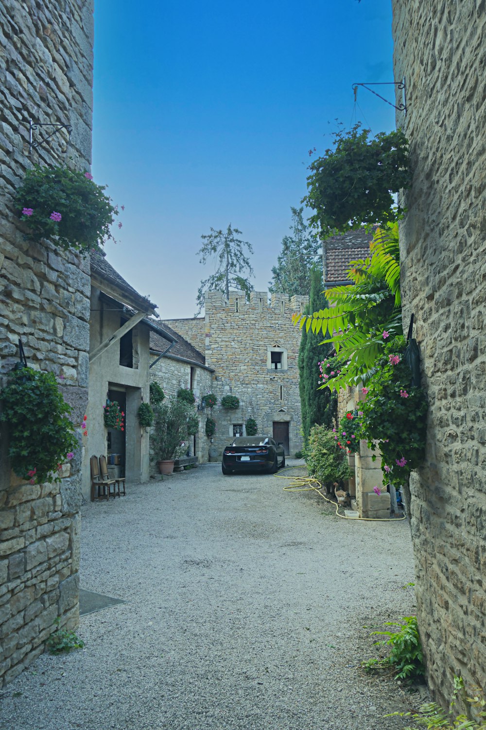 a car is parked on a cobblestone street