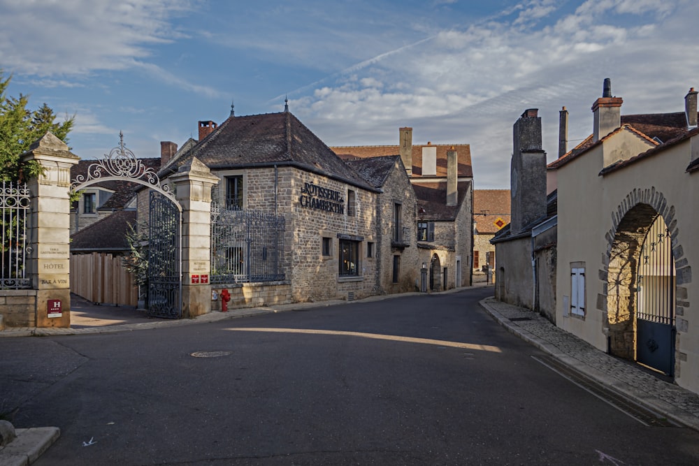 a street with a gate and buildings on both sides