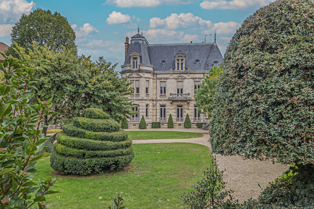 a large house surrounded by lush green trees