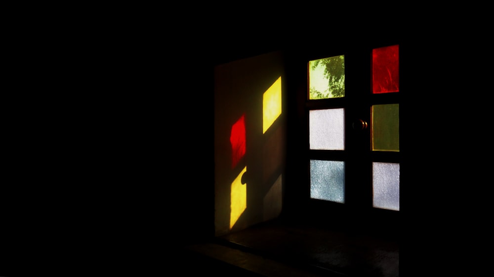a dark room with several different colored windows