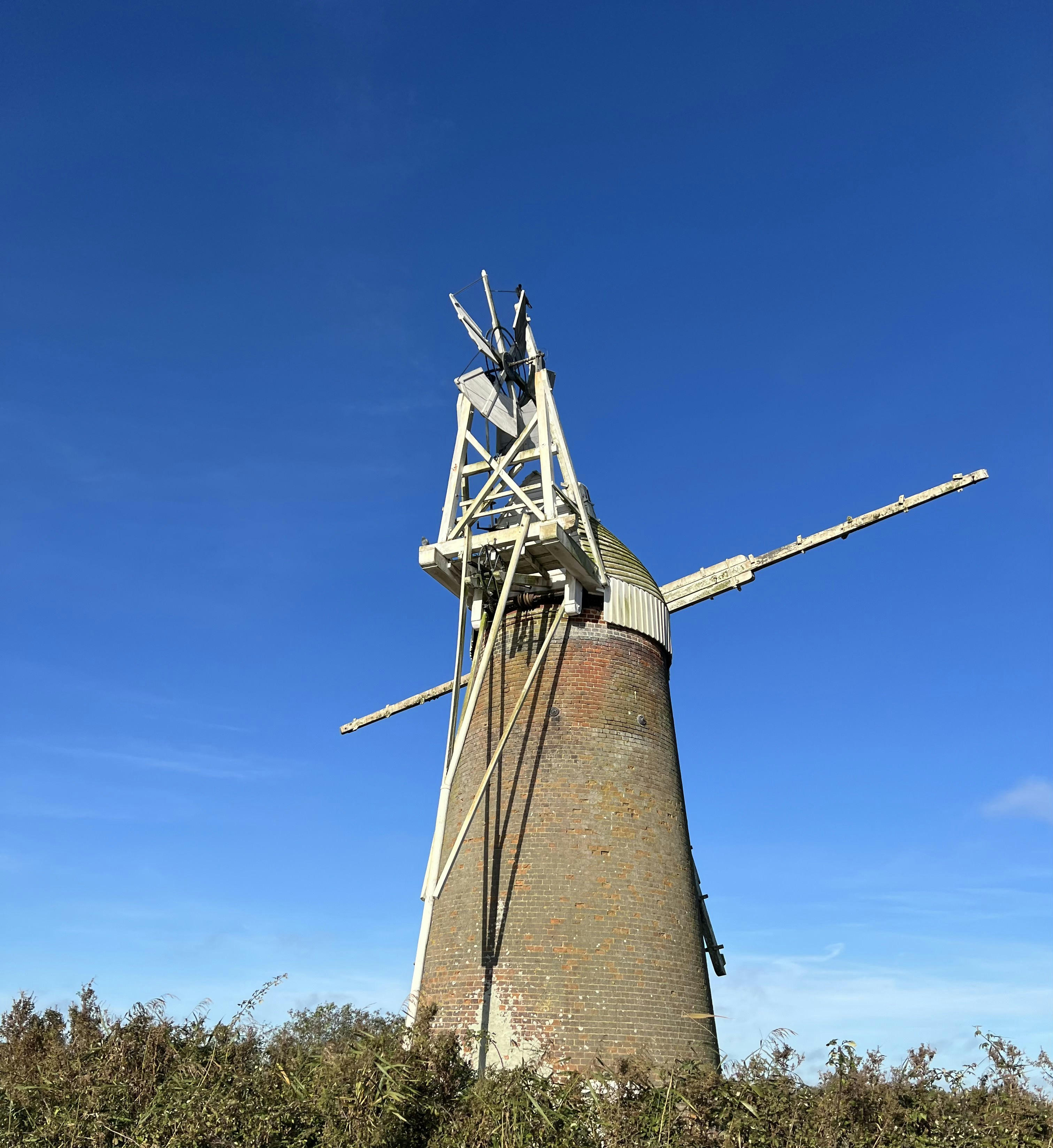 a windmill is shown against a blue sky