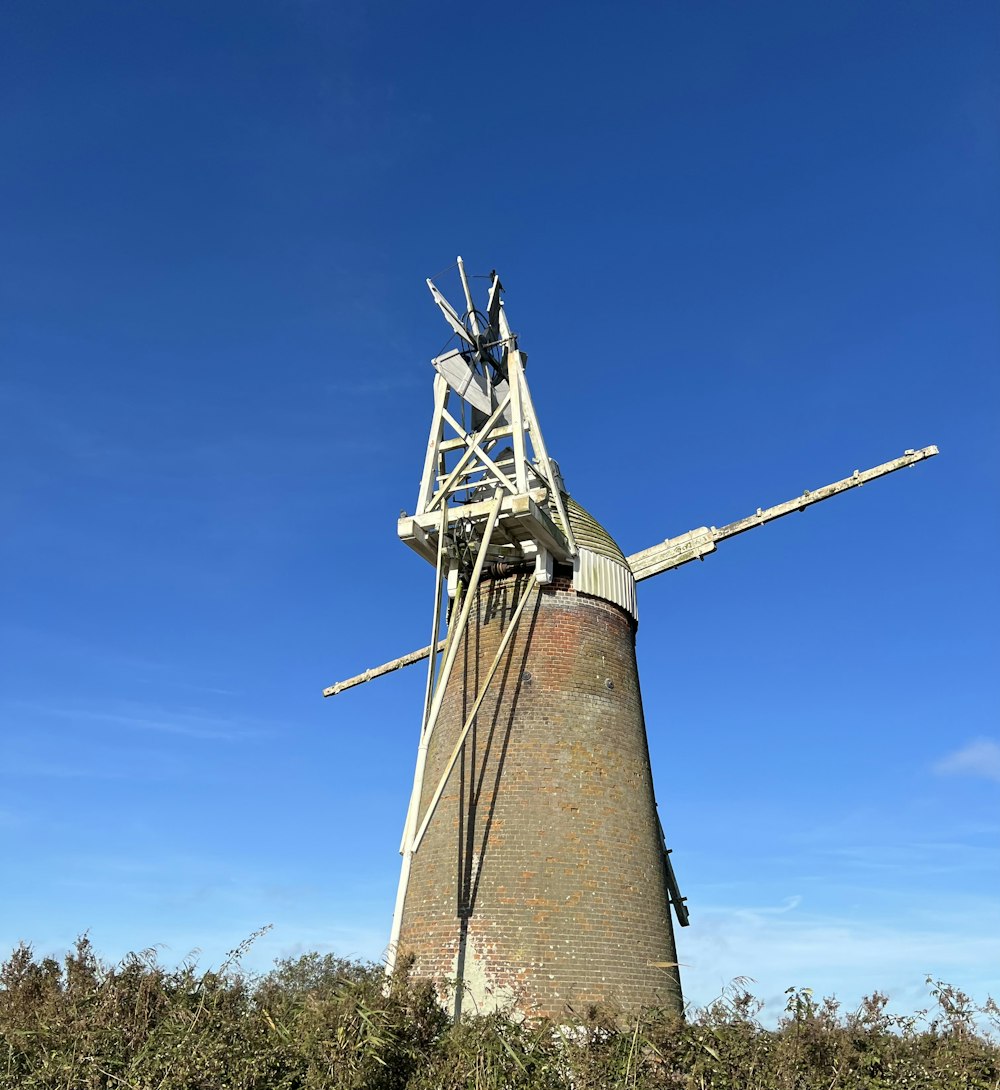 a windmill is shown against a blue sky