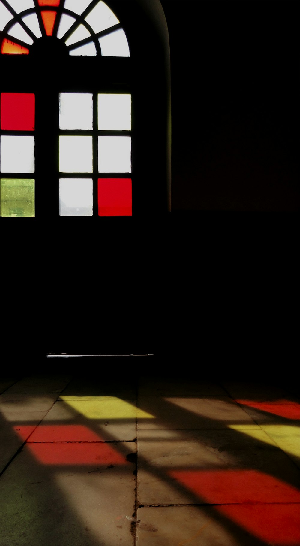 the shadow of a window on the floor of a building