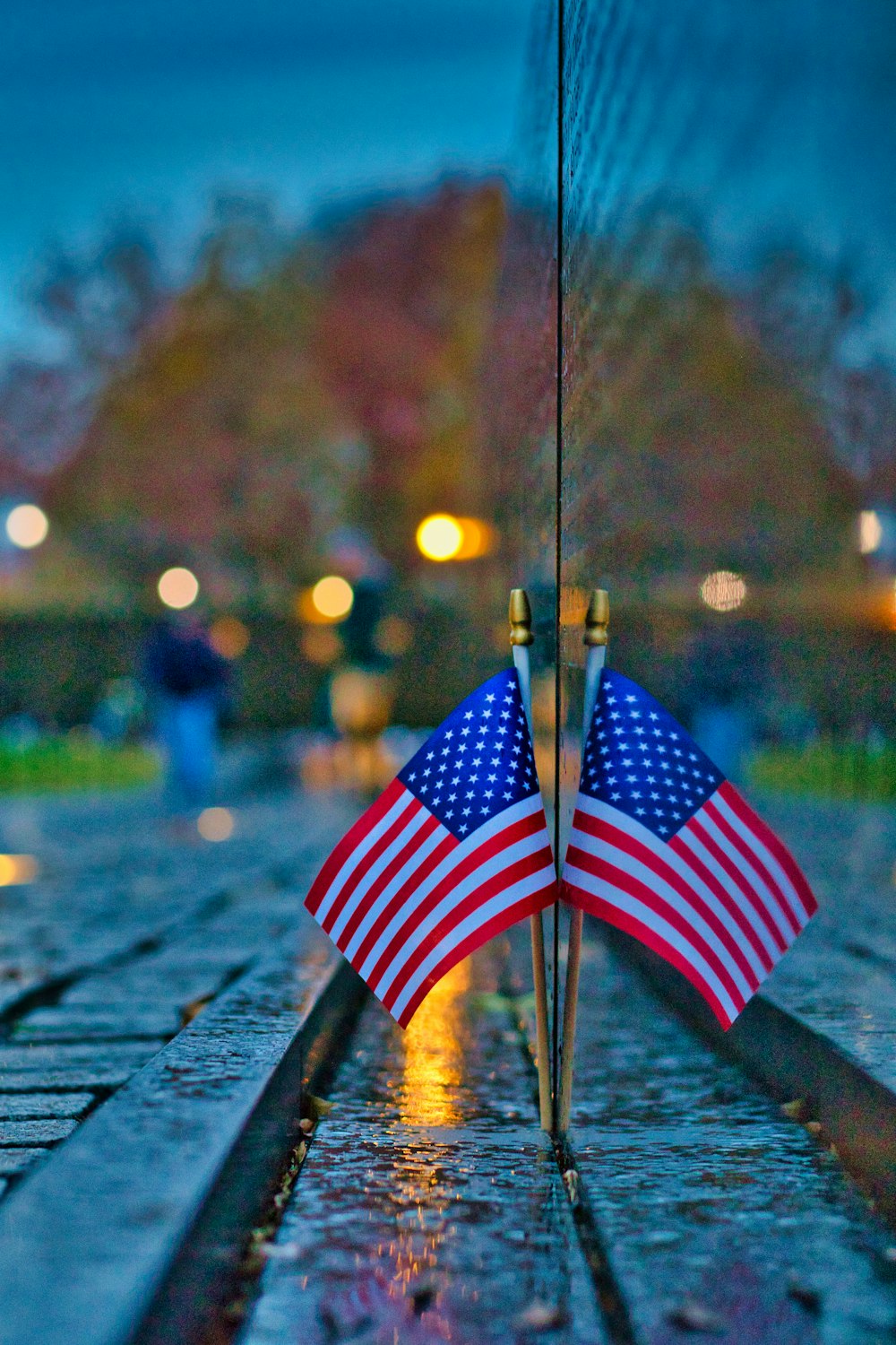 two american flags are placed on a memorial