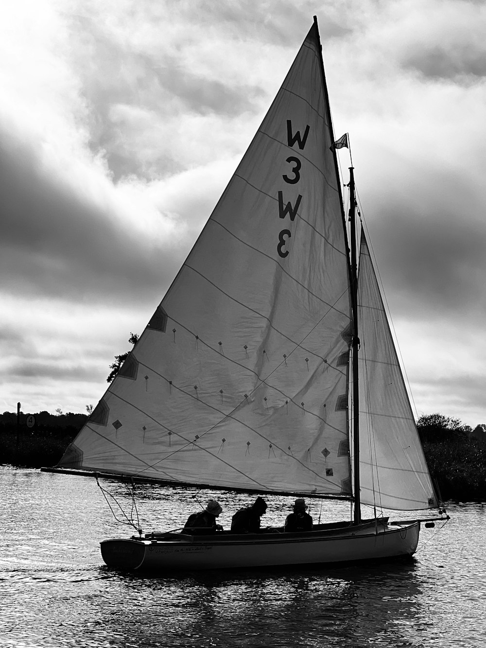 a black and white photo of a sail boat