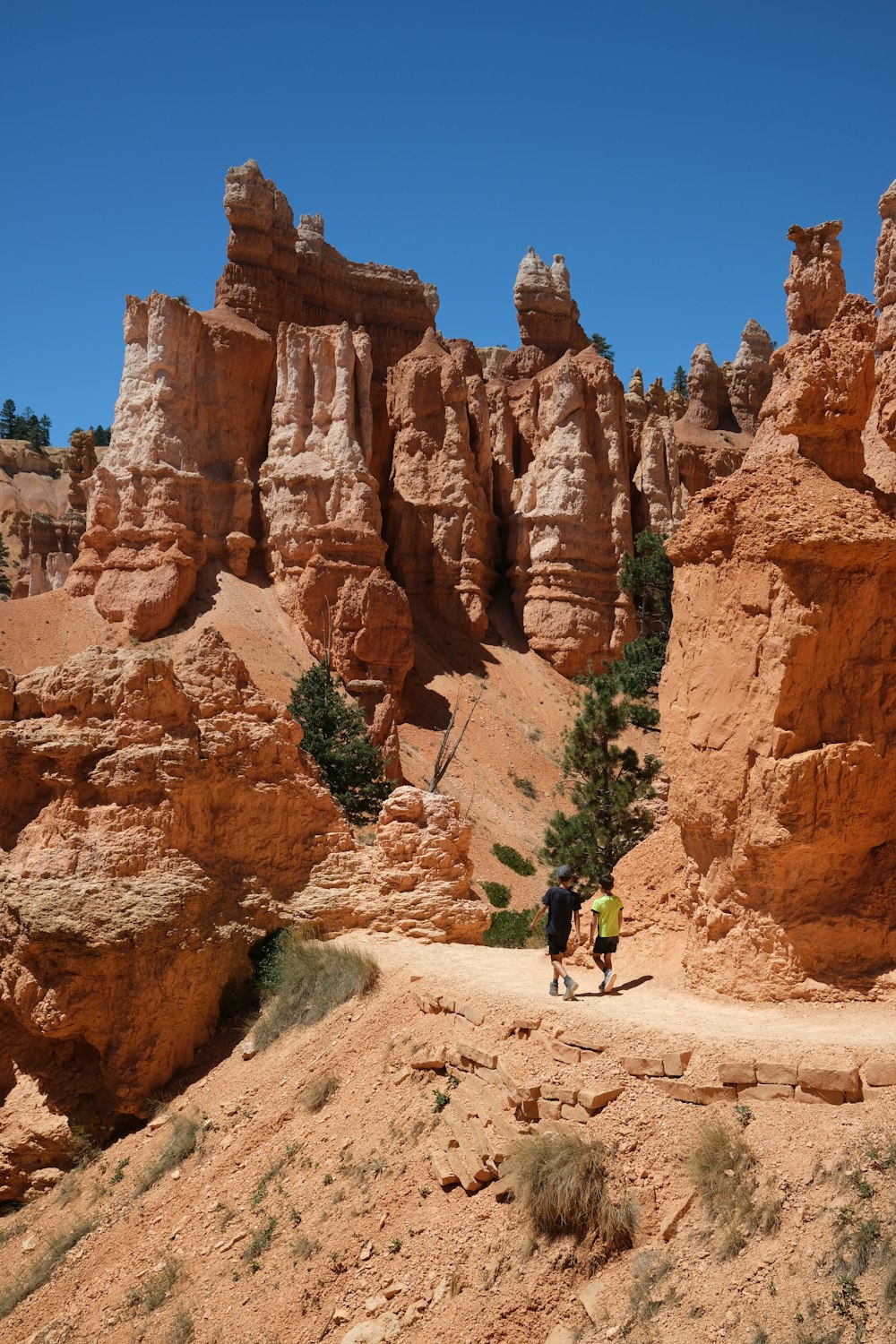 a couple of people that are standing in the dirt