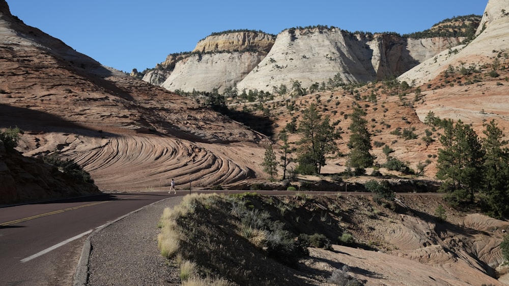 a scenic view of a mountain with a road going through it