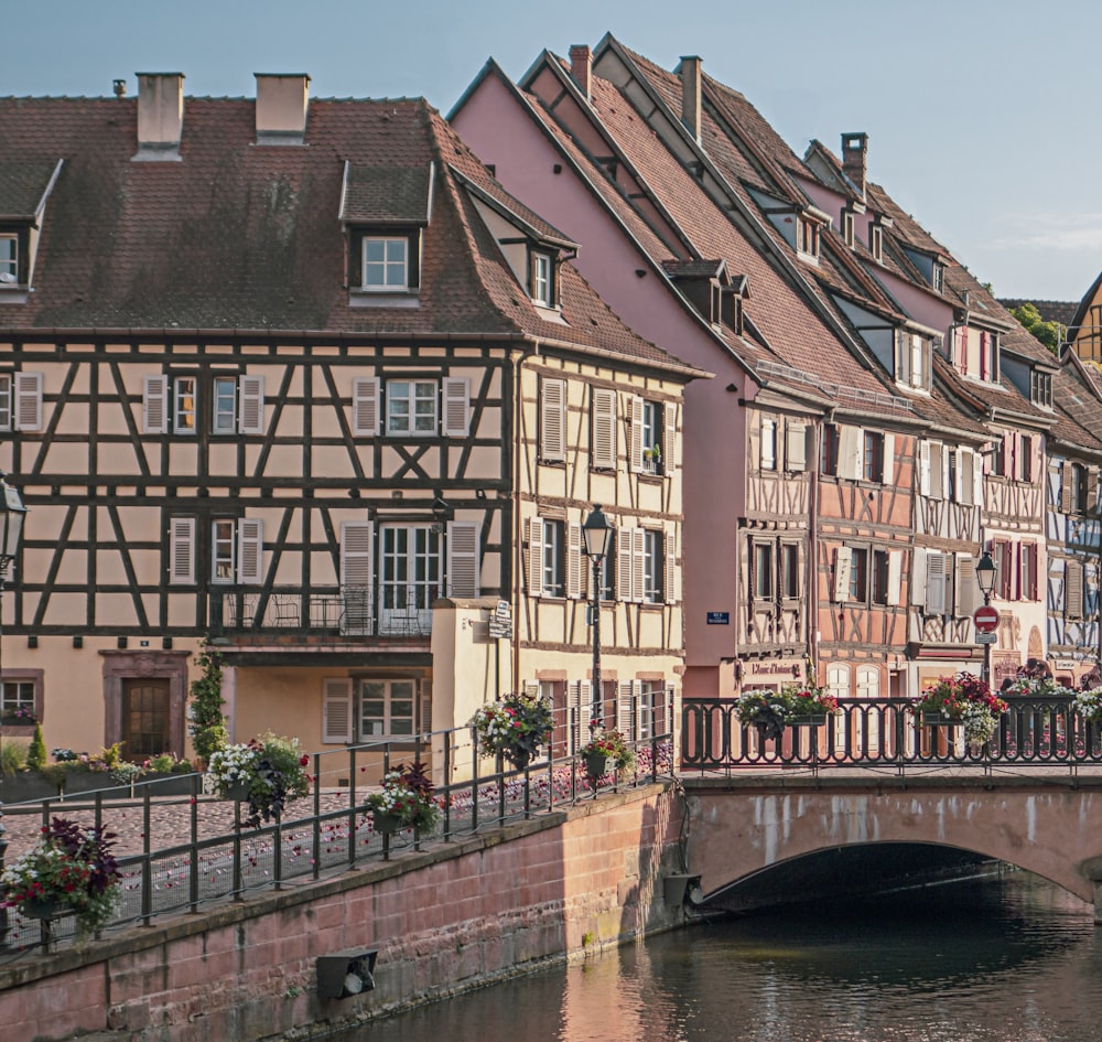 a bridge over a body of water in front of a row of buildings