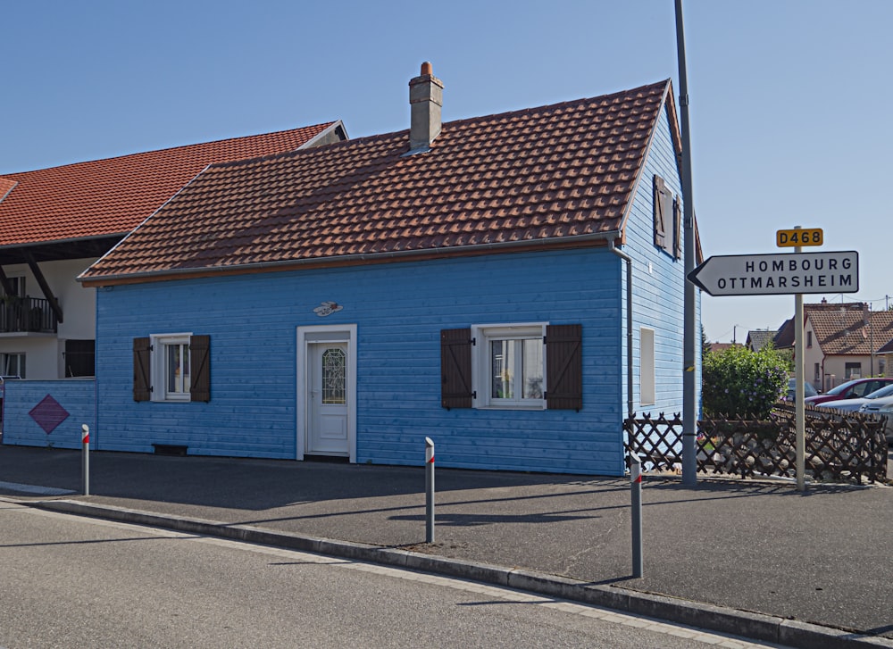 a blue house with a red tiled roof