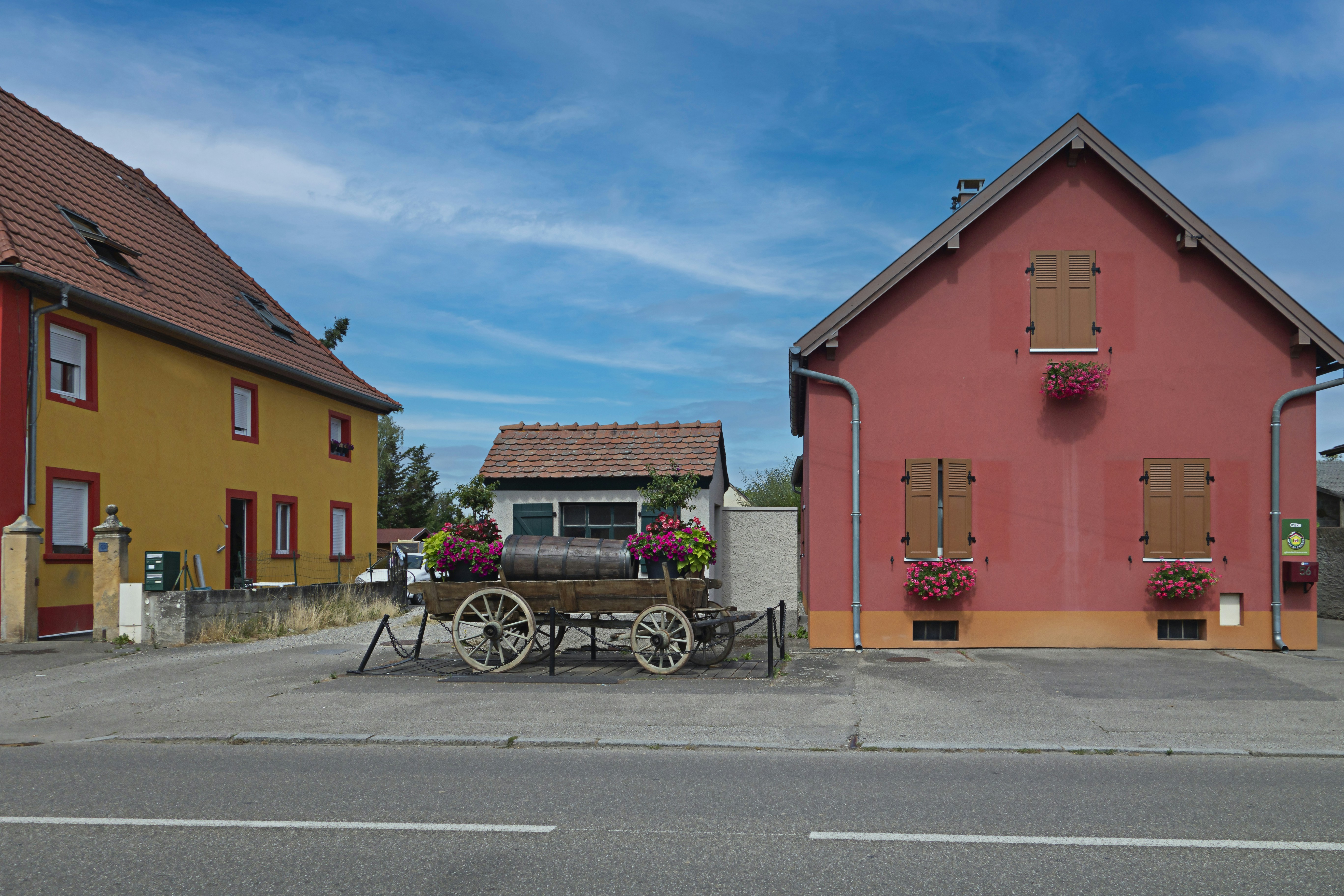 a horse drawn carriage sitting in front of a red building