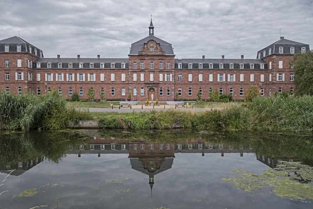 a large brick building sitting next to a body of water